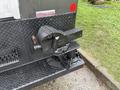 A close-up of the hitch and coupling mechanism on a 2006 Ford F-450 SD visible on the rear of the truck