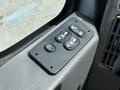 Control panel for window and door functions in a 2011 International 4300 truck featuring buttons for auto functions and locks