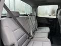 The interior of a 2015 GMC Sierra 1500 showing a gray cloth backseat with seat belts and headrests