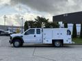 A 2008 Ford F-450 truck with a utility body featuring compartments and equipment for work functions