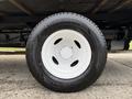 Close-up of a white tire mounted on a 2022 Ford E-450 showing tread detail and wheel rim with a five-bolt pattern