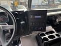 Interior dashboard of a 2020 Freightliner MT45 featuring a radio display controls and cup holders