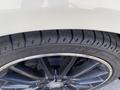 Close-up of a black alloy wheel with a shiny silver rim and a tire labeled Vantage 8 indicating tread pattern and size on a 2014 Mercedes-Benz CLA-Class