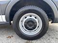 Close-up of a wheel from a 2016 Ford Transit 150 showing a silver rim and a black tire with tread pattern
