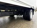 A 2024 Ford E-450 showing its undercarriage with visible suspension components and dual rear wheels