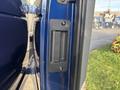 A 2013 Ford E-350 Super Duty door handle mounted on the side of the vehicle with a sleek black finish and a recessed design for easy gripping