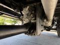 A close-up view of the drivetrain of a 2009 International 3000 CE bus featuring the transmission and driveshaft components