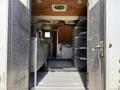 Interior view of a 2009 Kenworth T270 showing the cargo area with metal shelves and a sliding door at the back