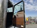 A 1996 Kenworth T800 truck door is open showing a brown and beige interior with a black handle and a view of the cabin through the glass window
