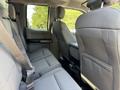 Interior view of the backseat of a 2017 Ford F-550 featuring gray fabric seats and seatbelts