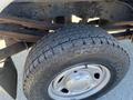 Close-up of a rugged tire mounted on a wheel showing treads and metal rim of a 2016 Ford F-250 SD