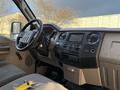 Interior of a 2010 Ford F-550 showing the steering wheel dashboard and control panel with a key fob on the seat