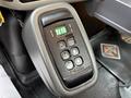 A black gear shift panel with buttons labeled for drive modes including reverse neutral and forward with a green digital display showing the current gear