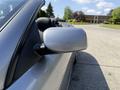 A silver 2004 BMW 6-Series convertible with a sleek exterior design and a side mirror prominently displayed