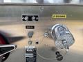 A metal panel from a 1999 Freightliner FL80 featuring gauges a pump heat indicator and a discharge connection with labels indicating their functions