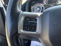 Close-up of the steering wheel controls of a 2018 RAM 3500 featuring buttons for voice recognition phone and navigation functions