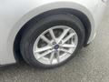 A close-up of a silver 2018 Ford Focus wheel featuring a five-spoke alloy rim and a black tire with visible tread