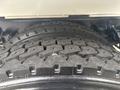 Close-up of the tire tread on a 2006 Freightliner M2 106 showcasing deep grooves and a robust design for traction and durability