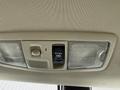 Overhead light control panel in a 2016 Mitsubishi Outlander featuring switches for the door light and a push button for tilting the sunroof