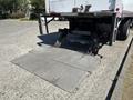 A Hino 338 truck with an extended loading ramp at the back ready for unloading cargo