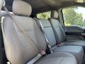 Interior of a 2019 Ford F-550 showing the front bench seat with three seat positions and seatbelts in place