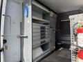 A 2017 Mercedes-Benz Sprinter van interior featuring metal shelving units with drawers and workspace storage