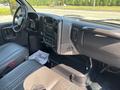 Interior of a 2005 GMC C7500 Topkick featuring black leather seats and a dashboard with controls and an audio system