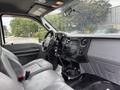 Interior view of a 2014 Ford F-550 truck with gray seats and dashboard featuring audio controls and various knobs and buttons for vehicle functions