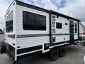 A 2022 Keystone Hideout RDWE 20RDWE travel trailer with a sleek white and black exterior featuring large windows and the word "HIDEOUT" prominently displayed on the side