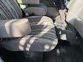A driver's seat of a 2008 Kenworth T370 with a patterned fabric cover and armrest shown from the side