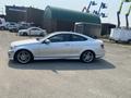 A silver 2013 Mercedes-Benz C-Class coupe parked with a sleek profile and sporty design showcasing alloy wheels and distinctive body lines