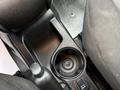 A close-up of the center console of a 2017 RAM ProMaster City featuring a cup holder and a gear shift lever