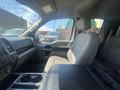 Interior of a 2019 Ford F-150 featuring a spacious front seat with grey fabric upholstery and a center console