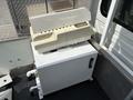 A 2012 International 7300 Workstar with a white storage compartment and a gray metal base showing various components and plumbing connections