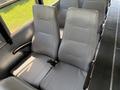 Interior view of a 2009 International 3000 CE school bus featuring two gray vinyl seats with vertical ridges and seatbelts
