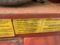 A 2000 Baldor Air compressor with various installation and electrical instruction labels attached to its surface