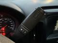 A steering column with a gear shift lever displaying buttons for plus and minus adjustments in a 2017 GMC Sierra 3500HD