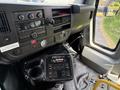 The interior dashboard of a 2017 Chevrolet Express featuring a control panel with various buttons and a radio system