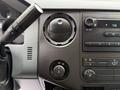A close-up view of the dashboard controls in a 2015 Ford F-350 SD featuring knobs for temperature and volume adjustment