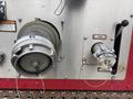 A 2006 E-One Typhoon fire truck pump panel featuring an intake valve and a discharge connection with hoses attached