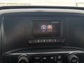 A dashboard display of a 2016 GMC Sierra 1500 showing audio and settings options with buttons below the screen