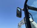 Close-up of the side mirror of a 2010 Bobcat E80 excavator showing the mirror's reflective surface and the arm attached to the cab