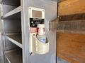 A dispenser for hand sanitizer mounted on a wall in a vehicle with a label indicating it is from Dynamic