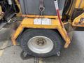 A 2015 Vermeer Corporation BC1200XL industrial wood chipper with a large wheel and yellow body showing signs of wear and tear