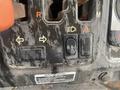 Control panel of a 2010 Kubota RTV 900 featuring various switches and indicators including lights and hazard signs