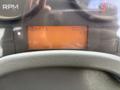 A dashboard view of a 2012 International DuraStar 4300 showing a digital display with readings for RPM and speed in kilometers per hour