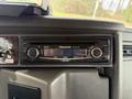 Dashboard view of a Panasonic MP3 car stereo in a Kenworth T370 truck featuring buttons for volume and track selection