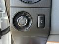 A control panel featuring a rotary dial with markings for lights and fog lamps alongside a button for additional lighting functions