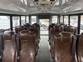 Interior of a 2021 Ford Econoline with brown leather seats facing forward and no passengers