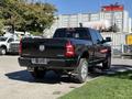 A black 2021 RAM 3500 pickup truck parked with a clear view of its rear and side features including its chrome accents and 4x4 badge